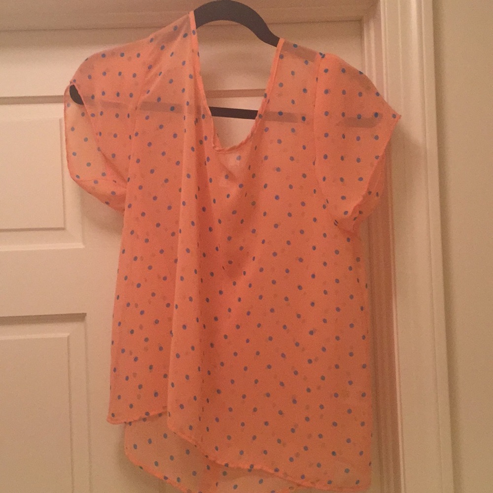 A pooka dot shirt that has buttons on the back